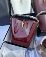 شنطة YSL Bucket Bag  - لون مارون لامع (Burgundy Patent) لإطلالة فخمة لا تُنسى